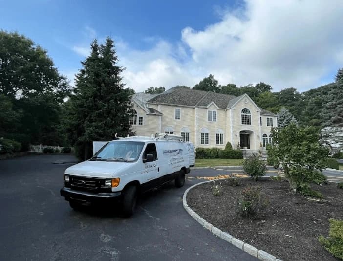 Green Power Washing technician performing thorough gutter cleaning service in Green