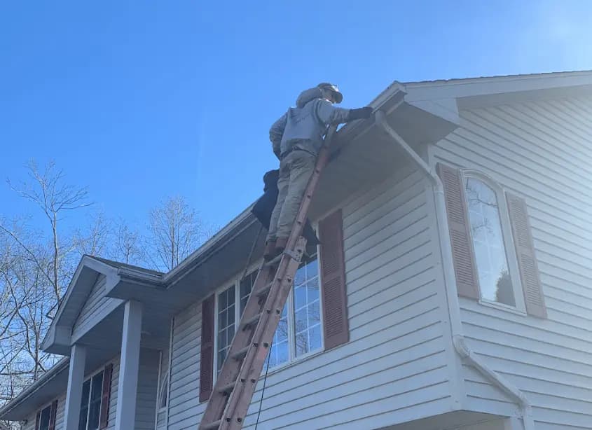 Gutter cleaning and maintenance being performed by Green Power Washing in Green