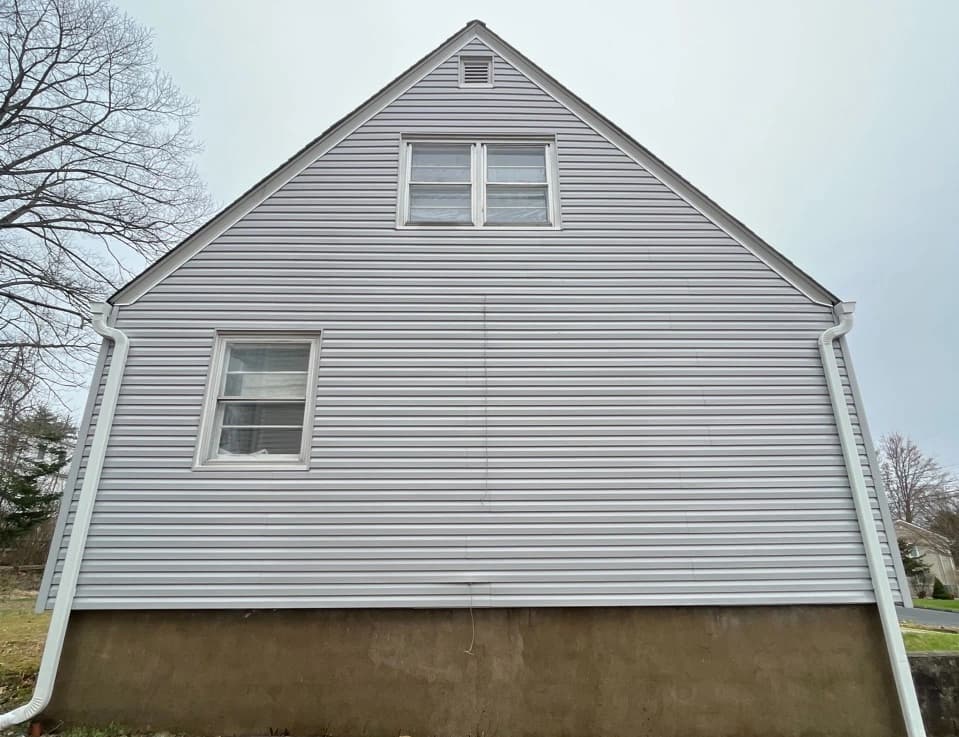 Green Power Washing technician performing detailed house washing in Green residential area